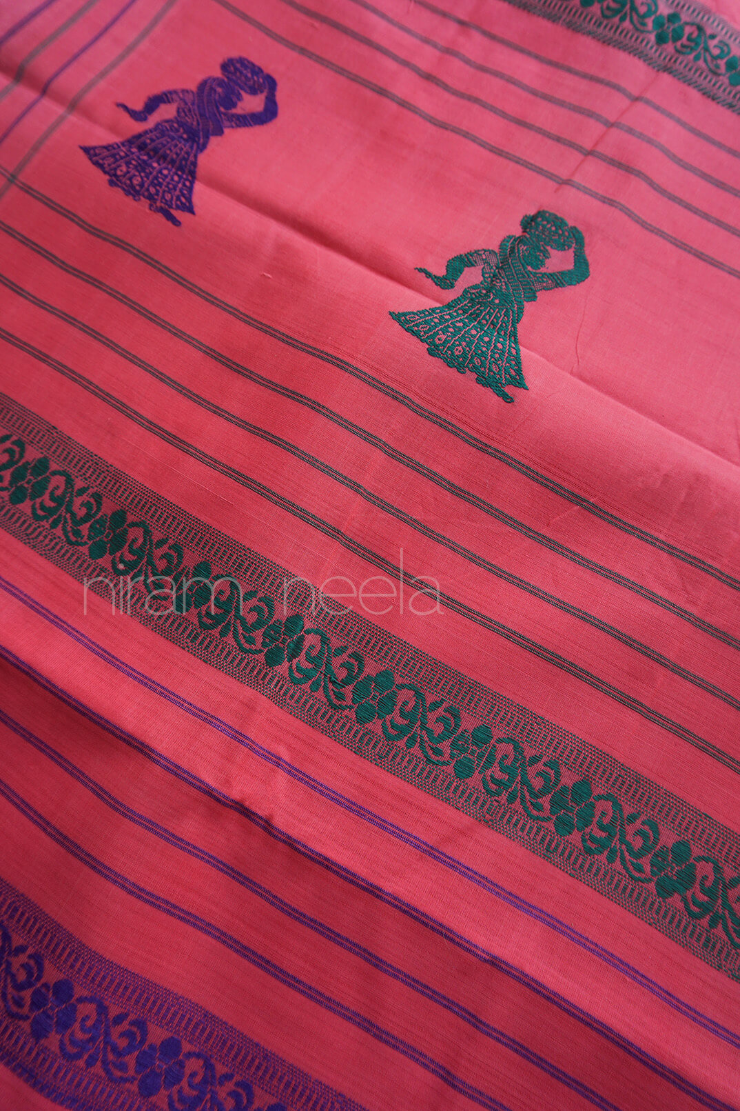 Peach fabric with blue patterns and text, featuring a design of a person and floral elements.