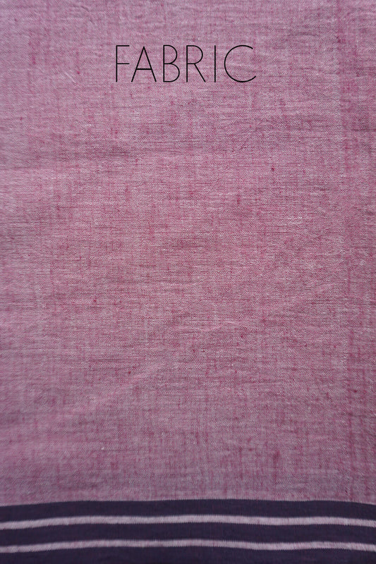 A close-up of a pale aubergine fabric sample with the word 'FABRIC' printed at the top and a black striped border along the bottom edge.