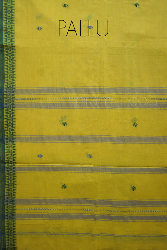 A close-up of a yellow saree with a dark green patterned border on the left, horizontal gray stripes, small green diamond motifs, and the word 'PALLU' printed at the top.