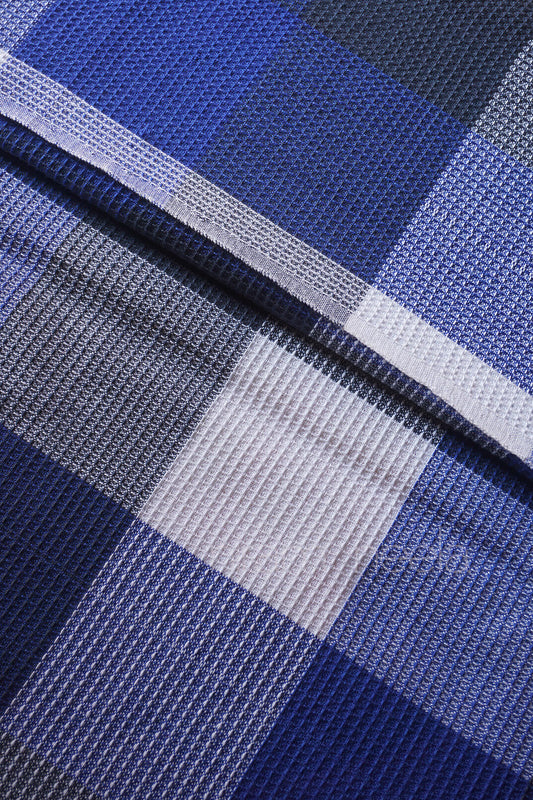Close-up of Blue and white checkered bedsheet | Home linen by Niram Neela