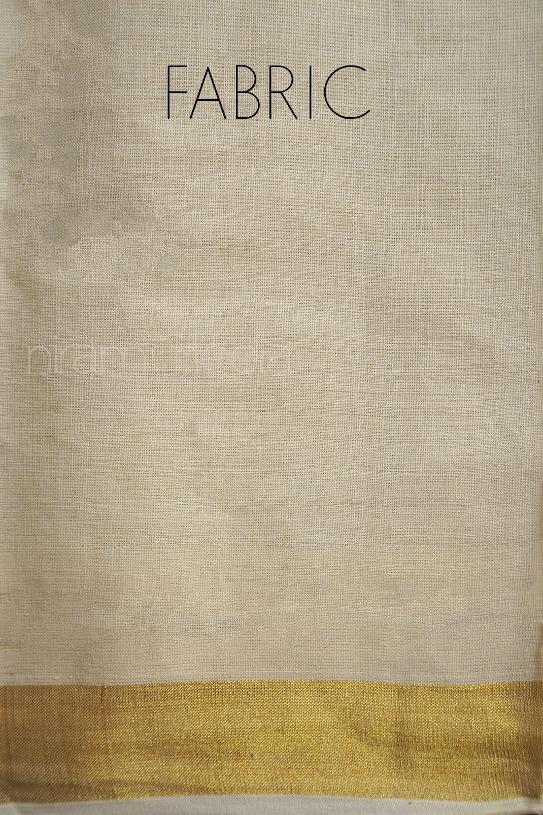 Cream fabric with a gold border on a textured dark surface | Niram Neela
