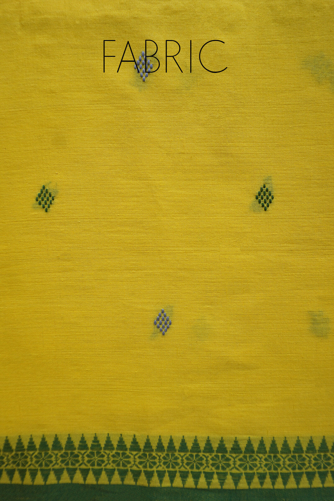 Yellow fabric with small dark geometric diamond motifs and a decorative border along the bottom edge. The word FABRIC is printed at the top.