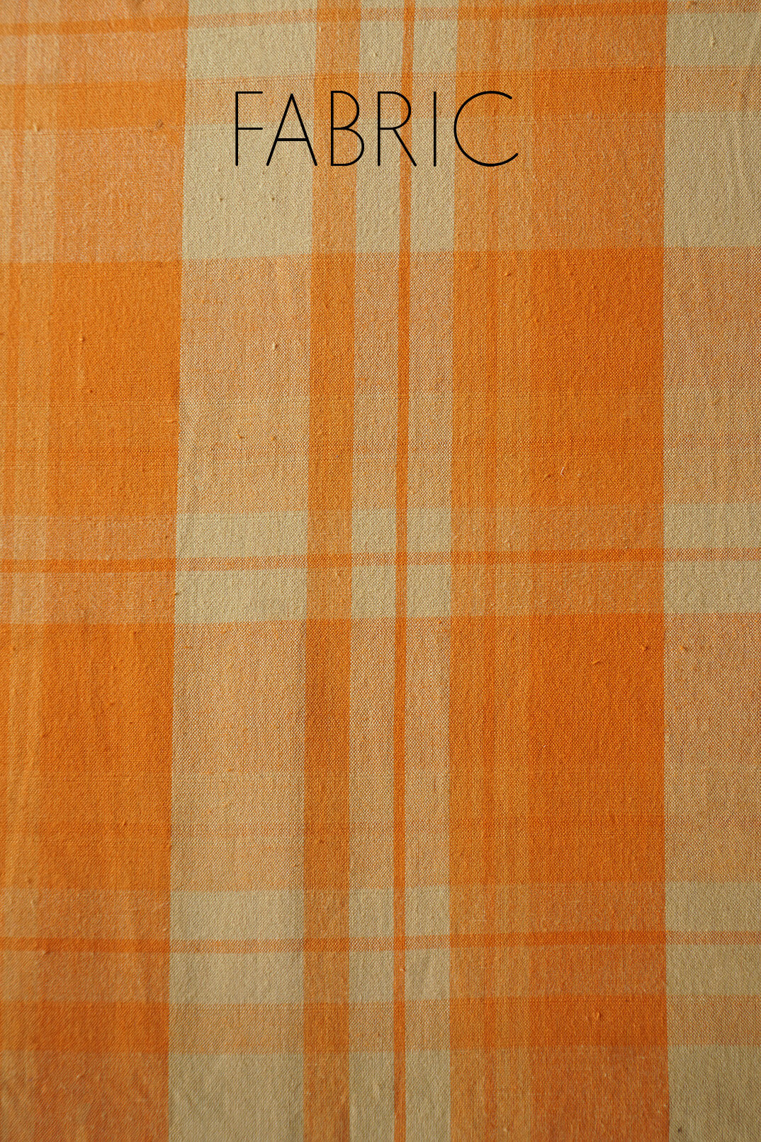 Bedsheet with orange and yellow colors and the word 'FABRIC' at the top.