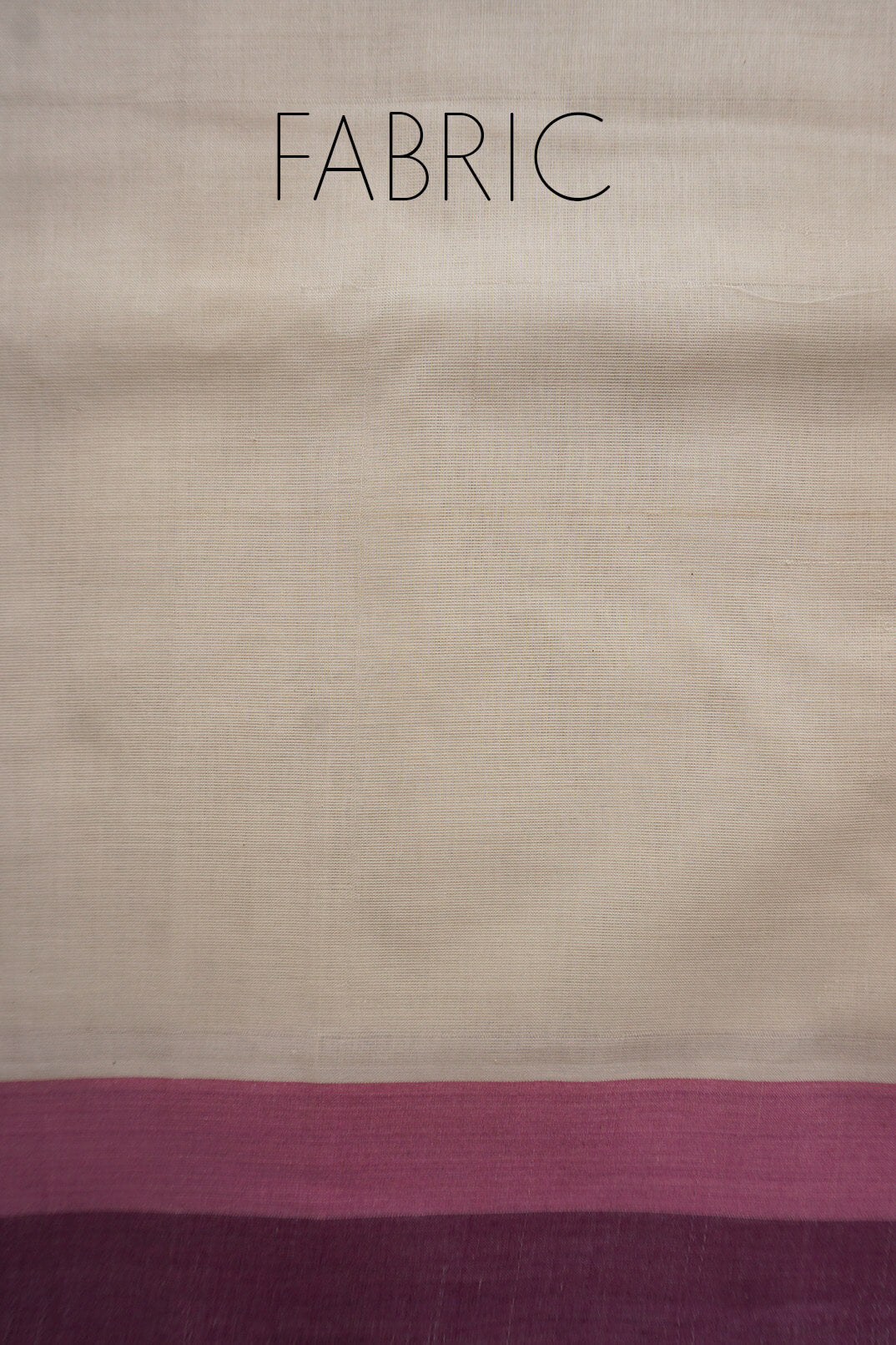 A close-up of saree with the word 'FABRIC' printed at the top, showing a cream base with a wide dusty pink band and a darker plum-purple band along the border.