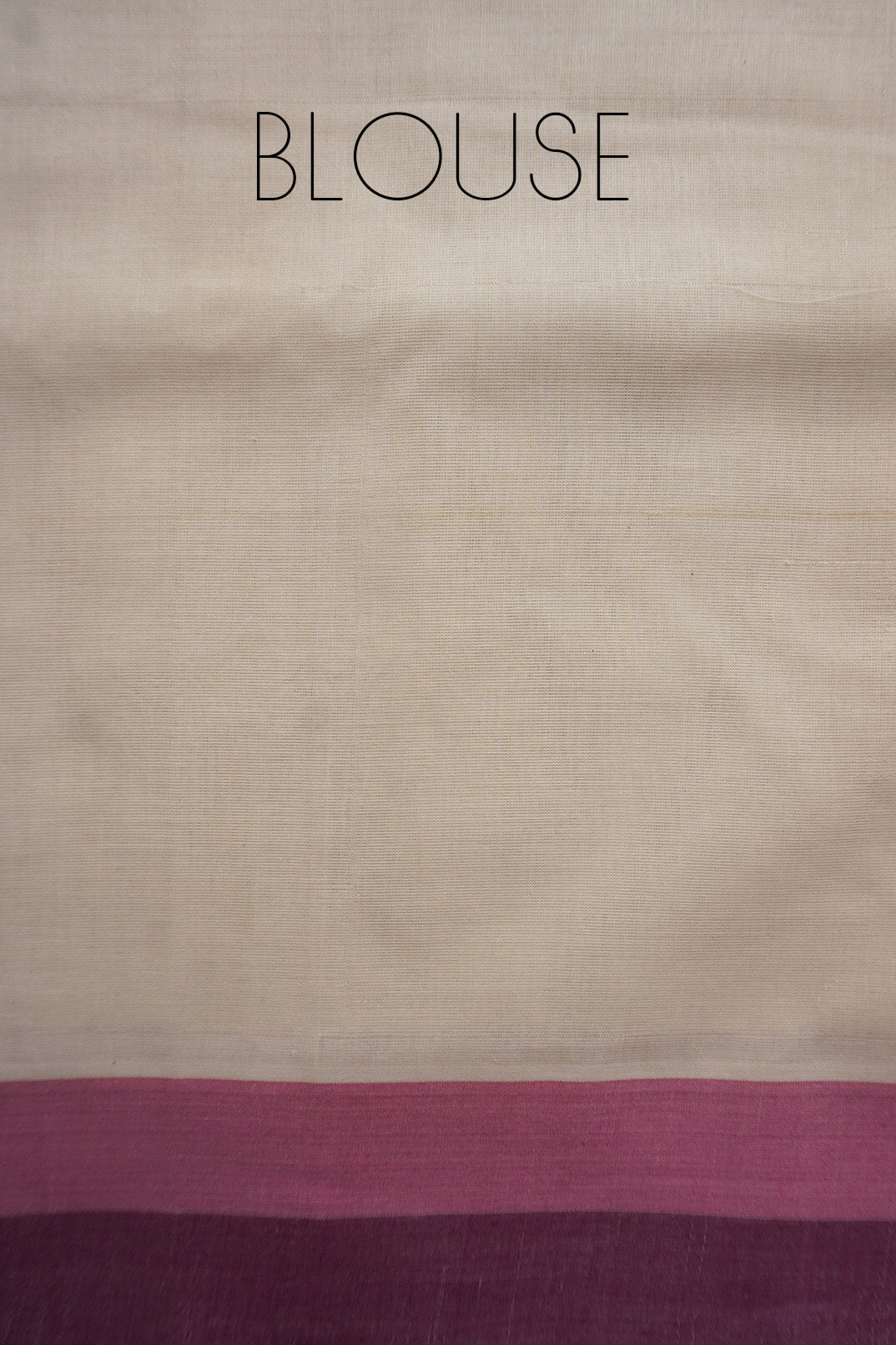 A close-up of a fabric blouse material with a cream body and two horizontal bands near the bottom in dusty pink and deep purple, with the word 'BLOUSE' printed at the top.