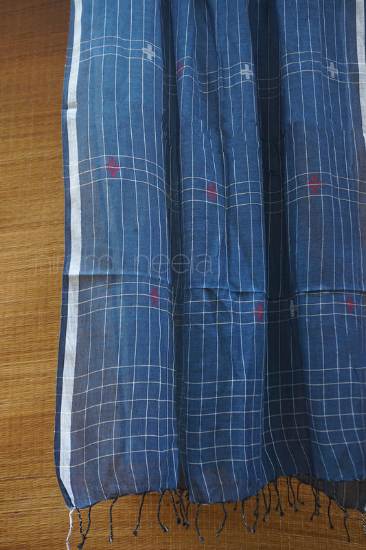 Blue checkered fabric with white stripes on a wooden surface