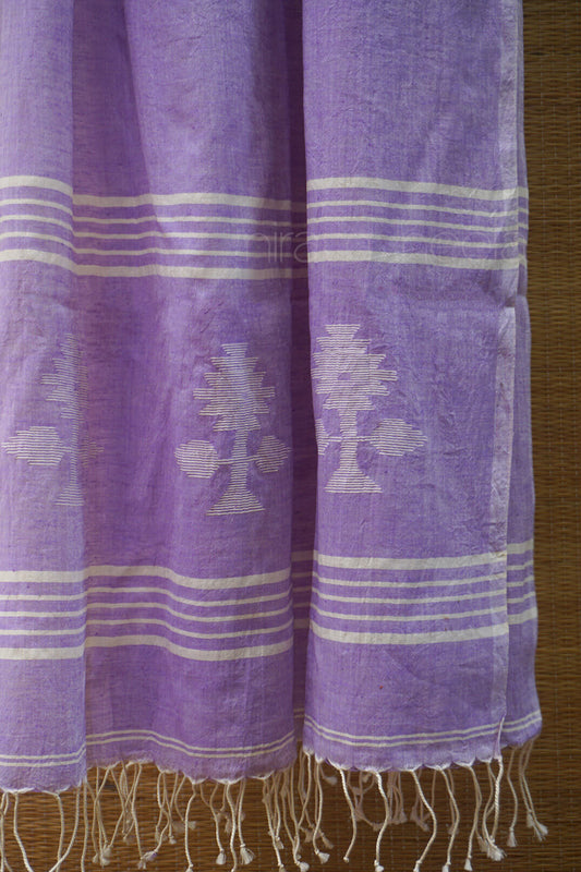 Soft violet scarf with white patterns and fringes on a wooden surface