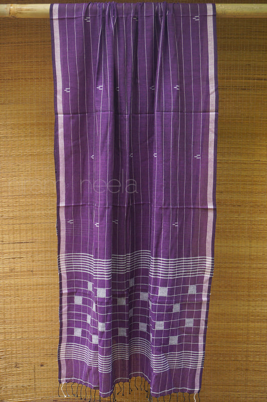 Purple and white patterned fabric on a wooden background