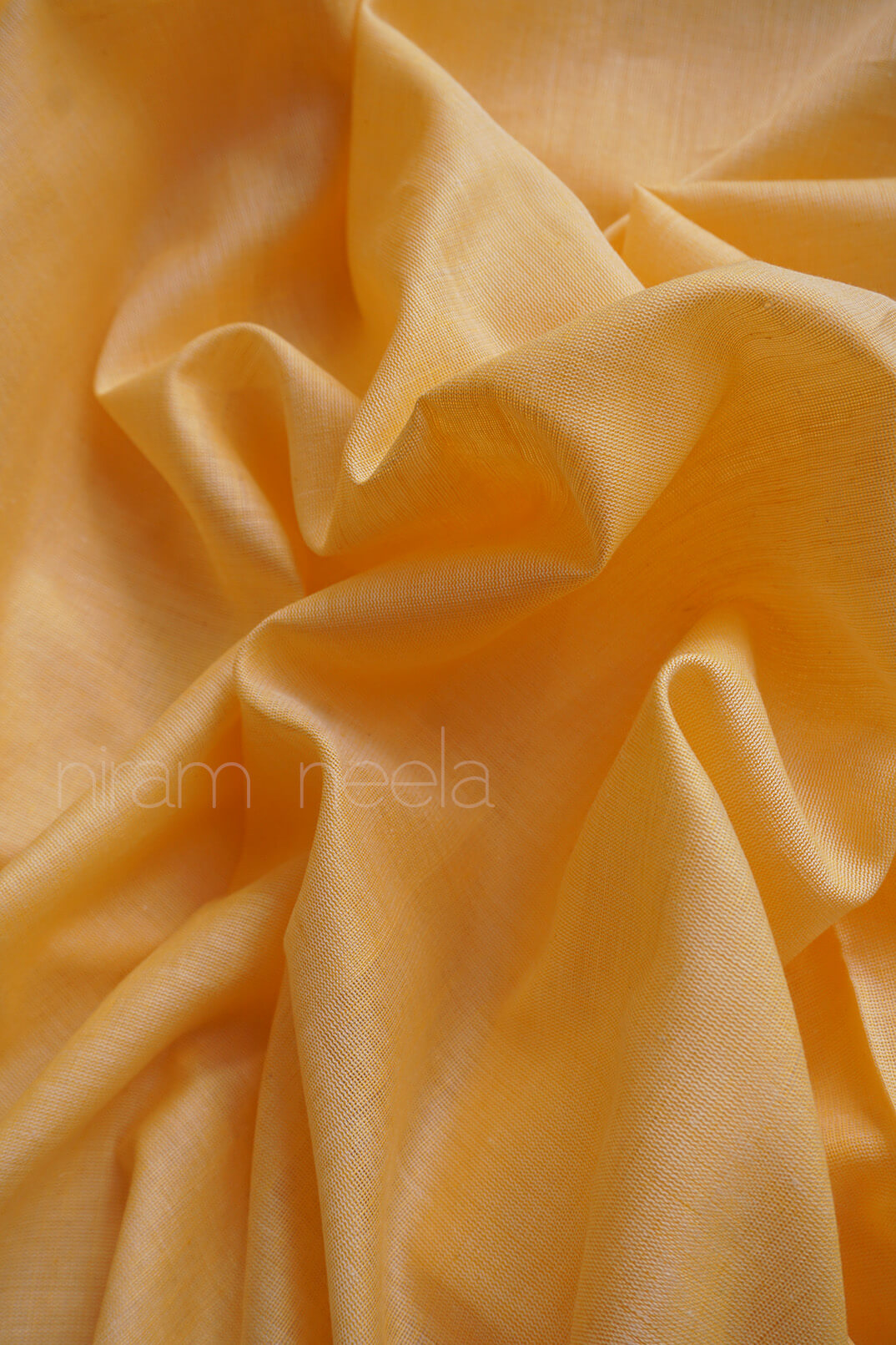 Close-up of a cream saree with purple and green border , brand 'niram neela' visible | Kozhikode saree  by Niram Neela