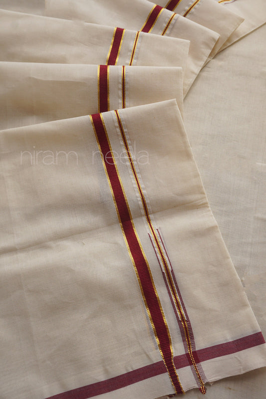 A close-up of folded off-white fabric with narrow vertical and horizontal maroon and gold stripes. A faint watermark reading 'niram neela' is visible across the fabric.