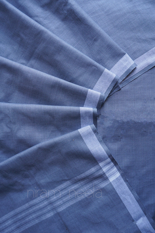 Close-up of grey dhoti with white stripes and border, brand 'Niram Neela' visible.