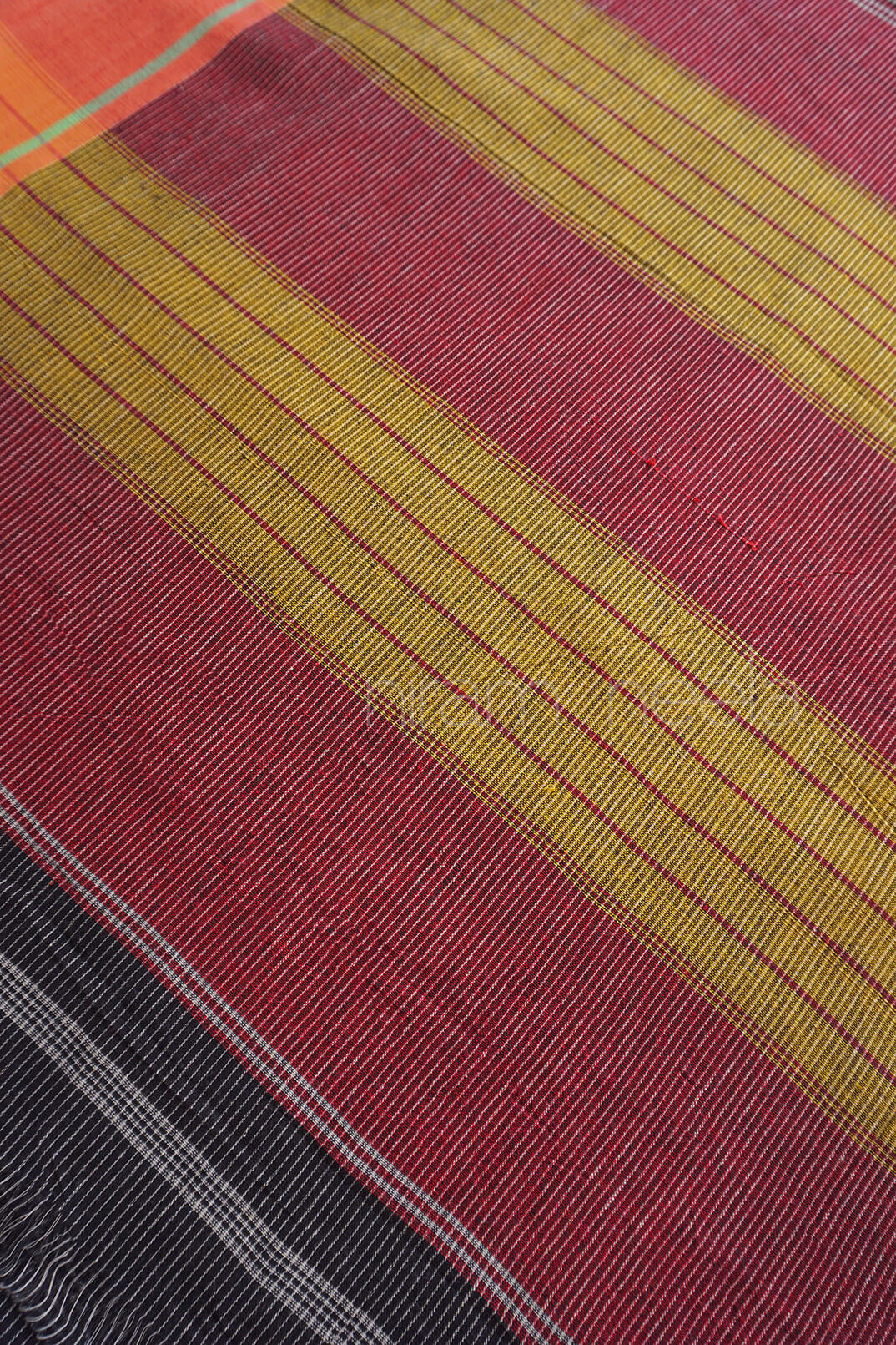 Textile with red and yellow diagonal stripes on a black background
